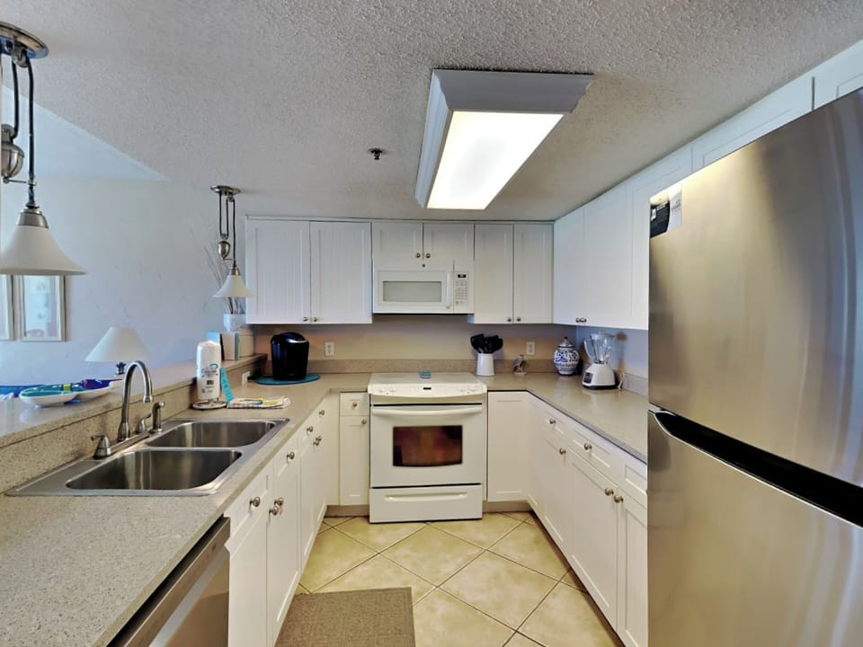 Condo, Multiple Beds, Balcony, Ocean View (Ocean Breeze West #106) | Private kitchen | Fridge, microwave, oven, stovetop