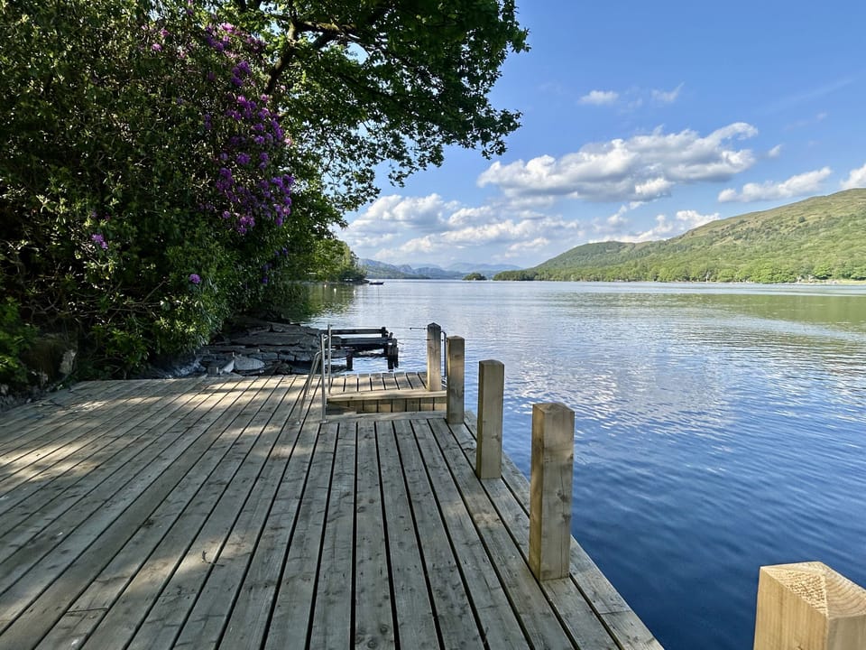 Tanglewood private jetty on Coniston Water with views of mountains beyond the lake