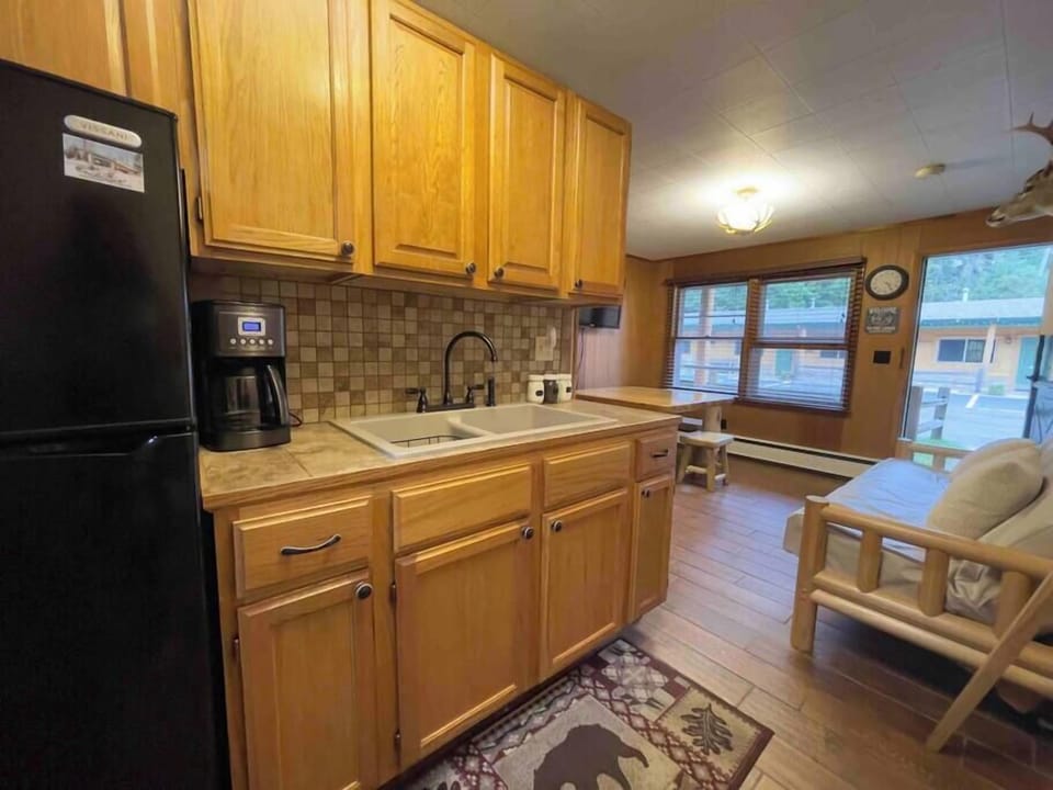 The kitchenette includes a mini fridge, coffee maker, kitchen sink and microwave.