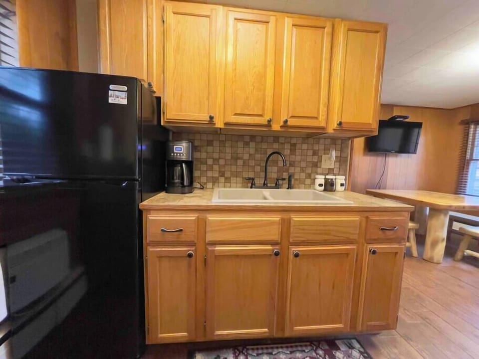 The kitchenette includes a mini fridge, coffee maker, kitchen sink and microwave.
