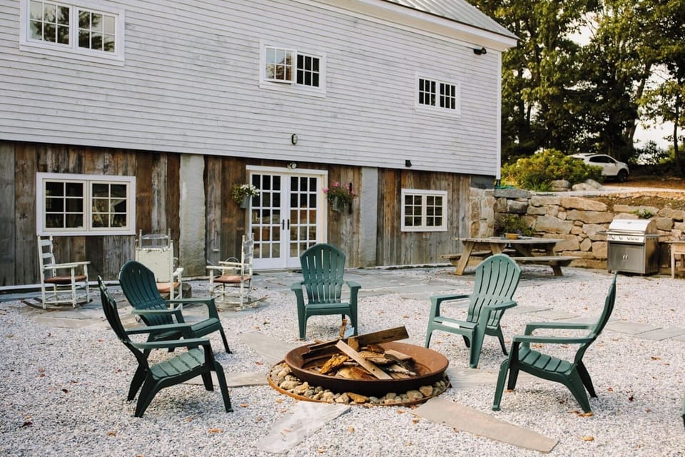 Private outdoor stone terrace with fire pit, gas grill and picnic table.