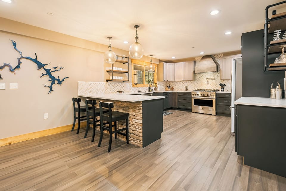 The kitchen is fully equipped and has seats for three at the breakfast bar.