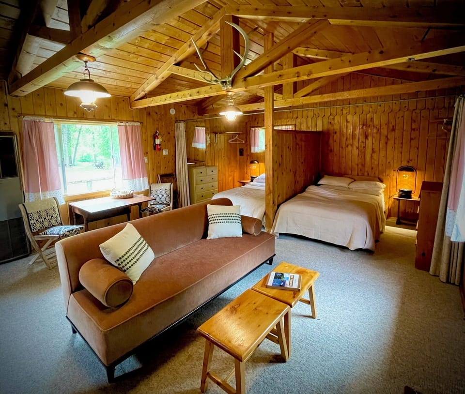 Open concept living room and sleeping space with privacy curtains that pull closed.