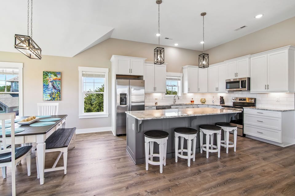 The open-concept floor plan keeps the family together with lots of sunshine and beneath high ceilings.