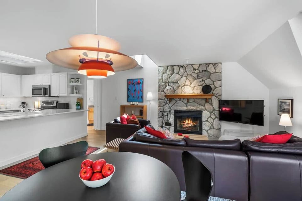 - Modern dining area with statement pendant lighting and art  
- Warm tones and sleek furniture create a cozy ambiance  
- Ideal for shared meals, game nights, and post-ski relaxation  