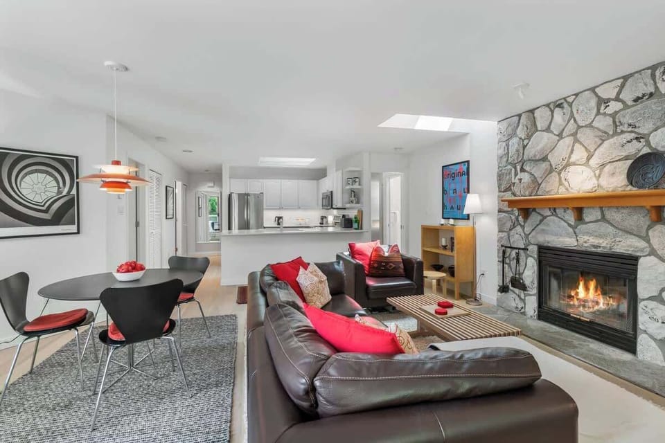 - Inviting lounge with stone fireplace and skylight lighting  
- Open layout connects seamlessly to kitchen and dining areas  
- Ideal for family gatherings after a day on the slopes  