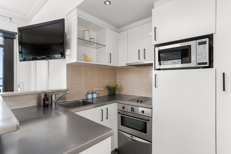 One Bedroom Apartment with Parking | Private kitchen | Fridge, microwave, oven, stovetop