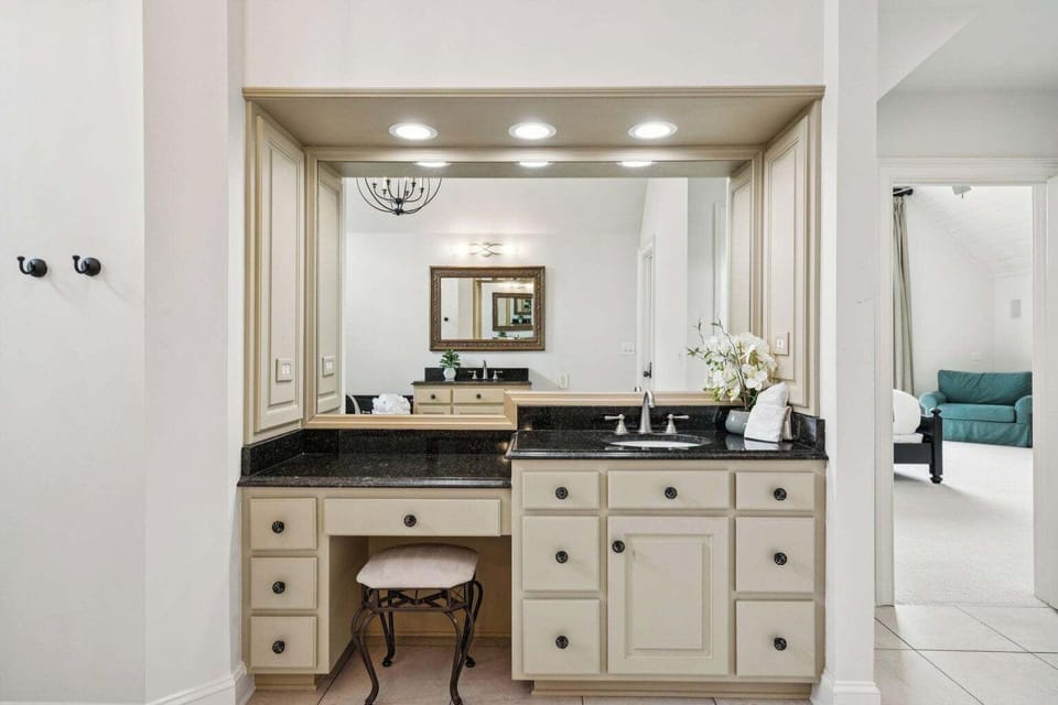 Your private vanity area features elegant dual sinks, granite counters, and a charming makeup station where you can prepare for your day.