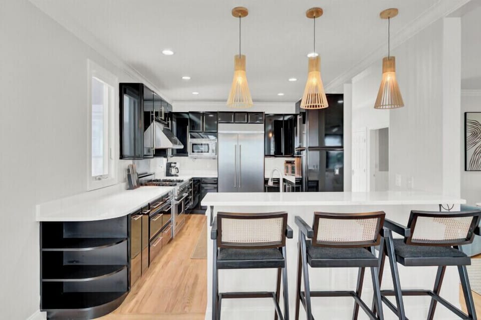 Your sleek modern kitchen features premium appliances, elegant pendant lighting, and a spacious island for cooking and entertaining together.