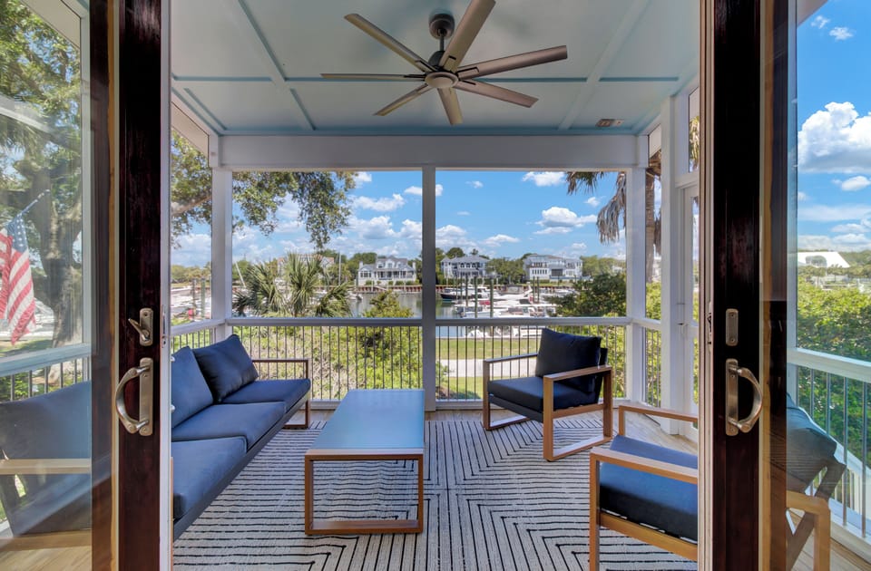 Your screened porch offers stylish seating with marina views where you can unwind while watching boats come and go.
