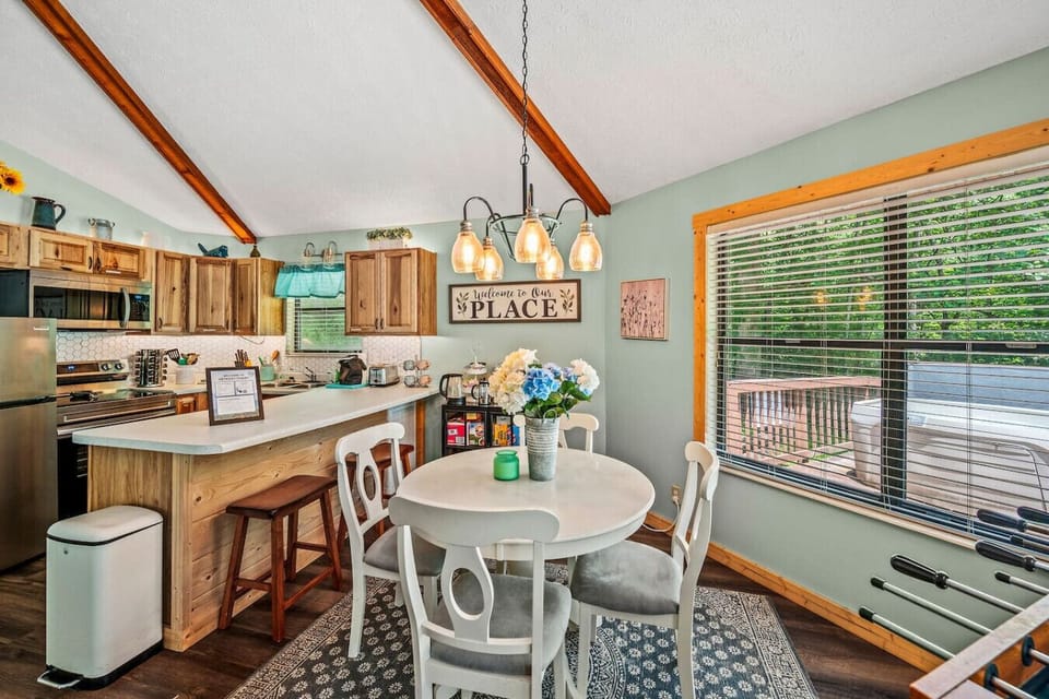 The dining table is conveniently located outside the kitchen and comfortably seats a group of 4.