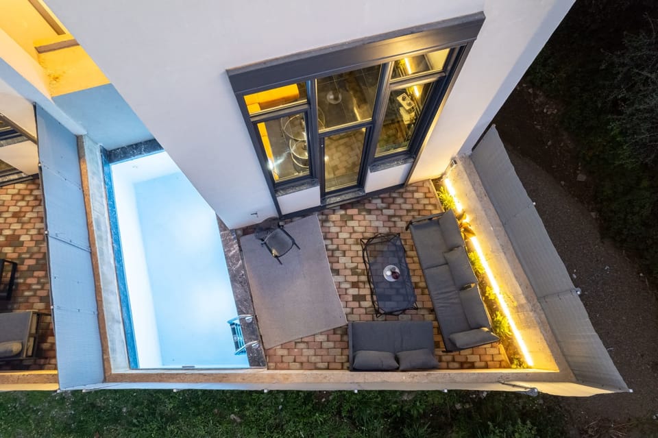 Private Patio with Poolside Lounge: Step outside into your inviting private patio, where comfortable outdoor seating and a refreshing swimming pool create