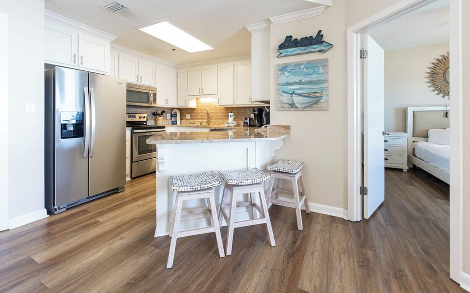 Gather around the stylish kitchen bar with seating, and enjoy the bright, inviting space perfect for family meals