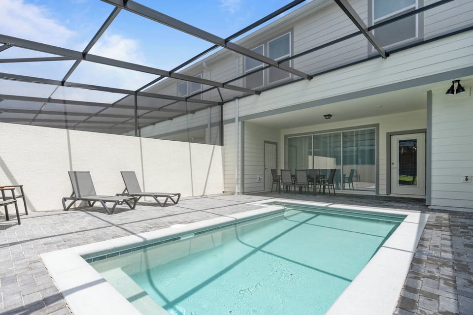 Step outside to your private pool area with sleek loungers beside refreshing waters, all enclosed stylishly for comfort. The bright, airy layout invites you to relax, making it perfect for unwinding or casual gatherings.