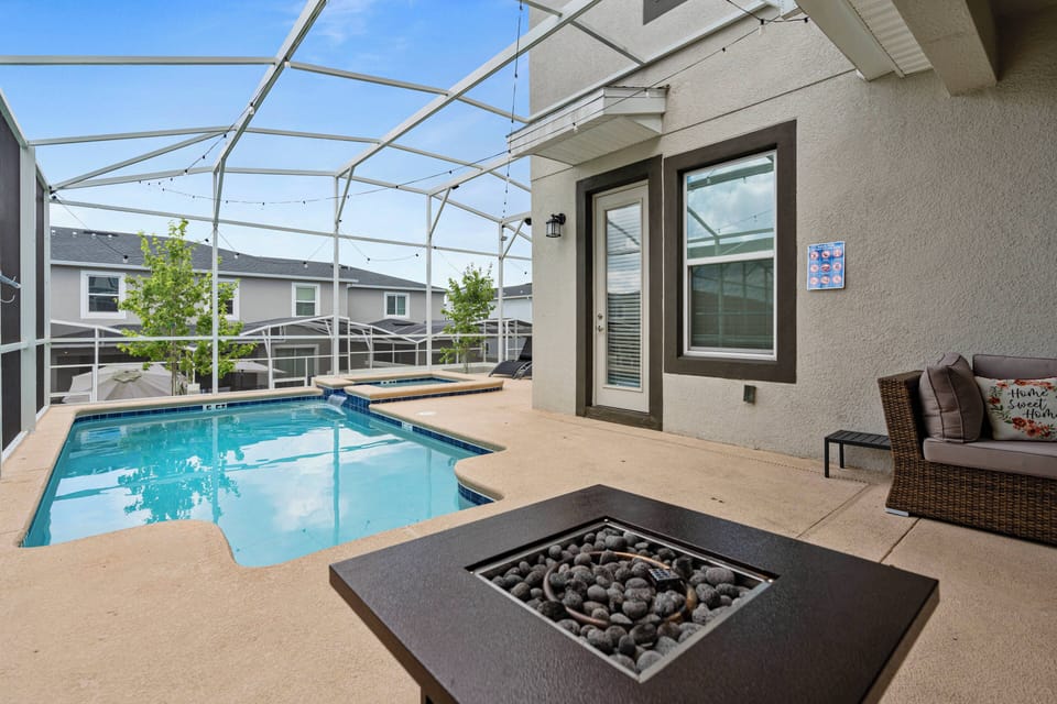Step into your private oasis with a crystal-clear pool and a cozy screened enclosure. Relax in the inviting seating area by the stylish fire pit, the ideal spot for unwinding and enjoying warm evenings.