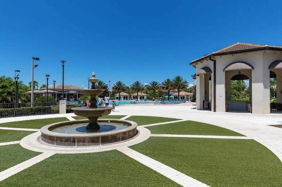 Step outside to a beautifully landscaped area with a serene fountain and lush greenery. The spacious patio is perfect for relaxation, allowing you to soak in the sun and enjoy the gentle breezes.