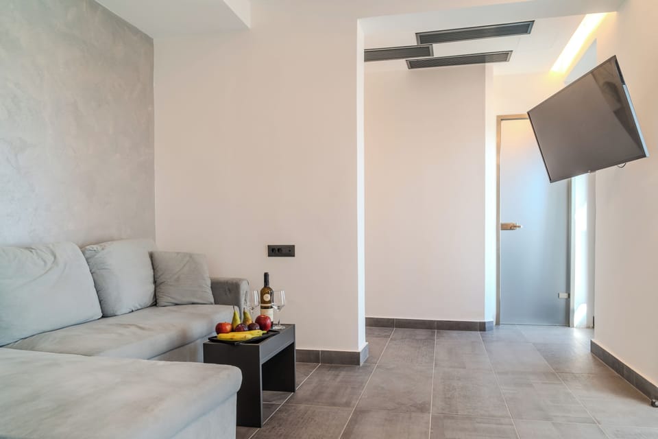 Family Double Room, Balcony | Living area | 43-inch TV with digital channels