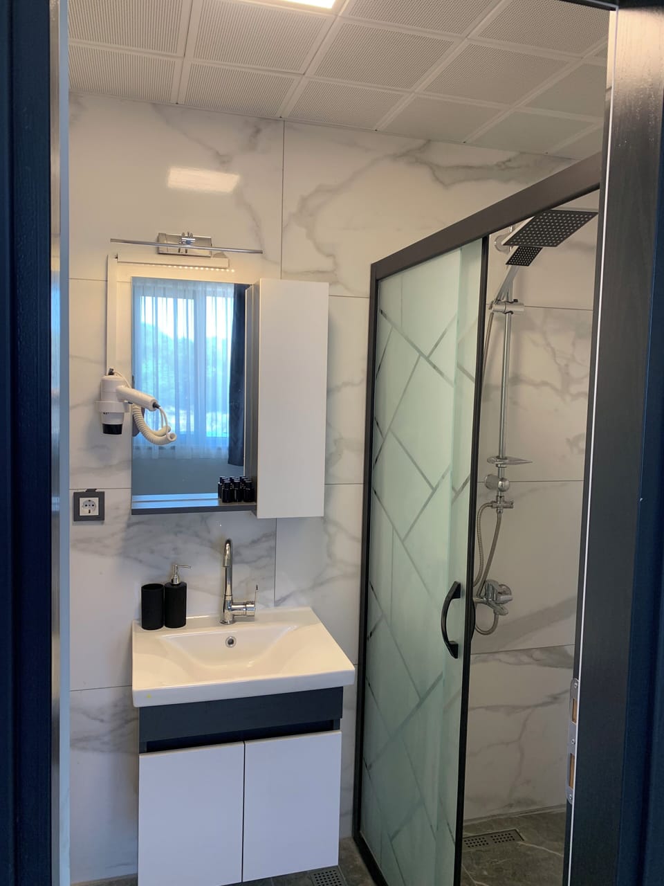 Shower, hair dryer, towels, soap