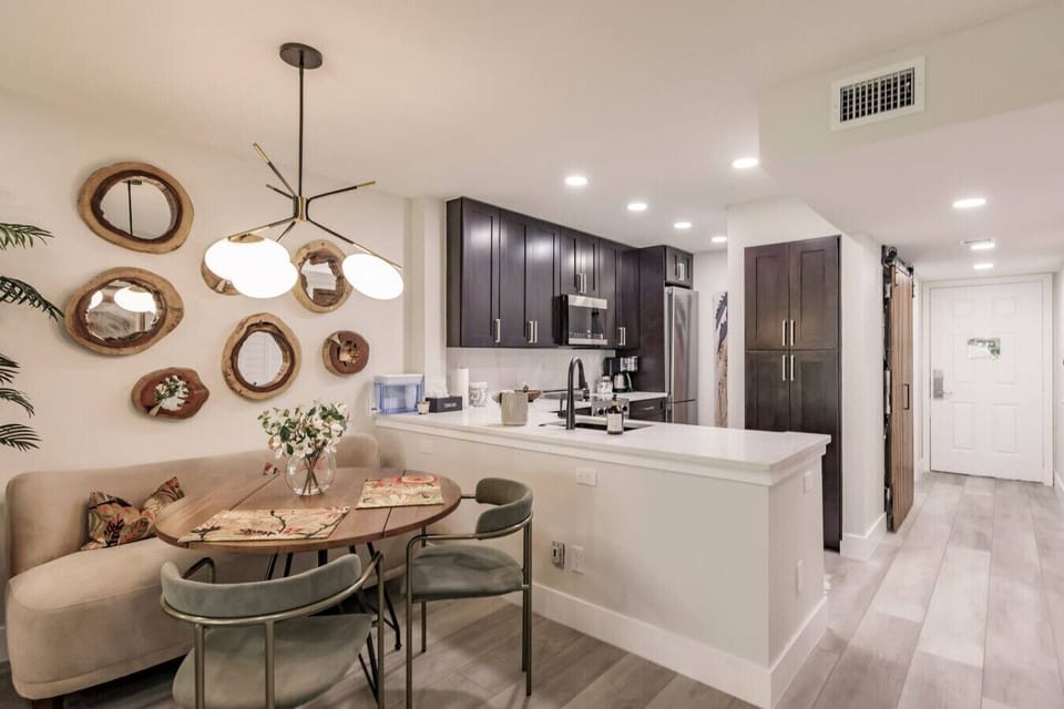 The dining table area with the kitchen in the background.