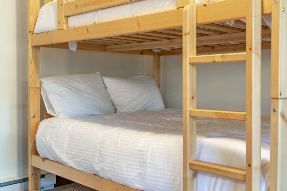 Second living room, located in the basement, with seating, Roku TV, double-over-double bunk & walkout patio access