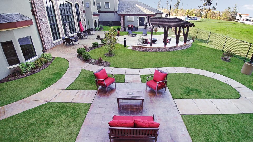 Enjoy the serene outdoor space, with comfortable seating and manicured lawns perfect for unwinding.