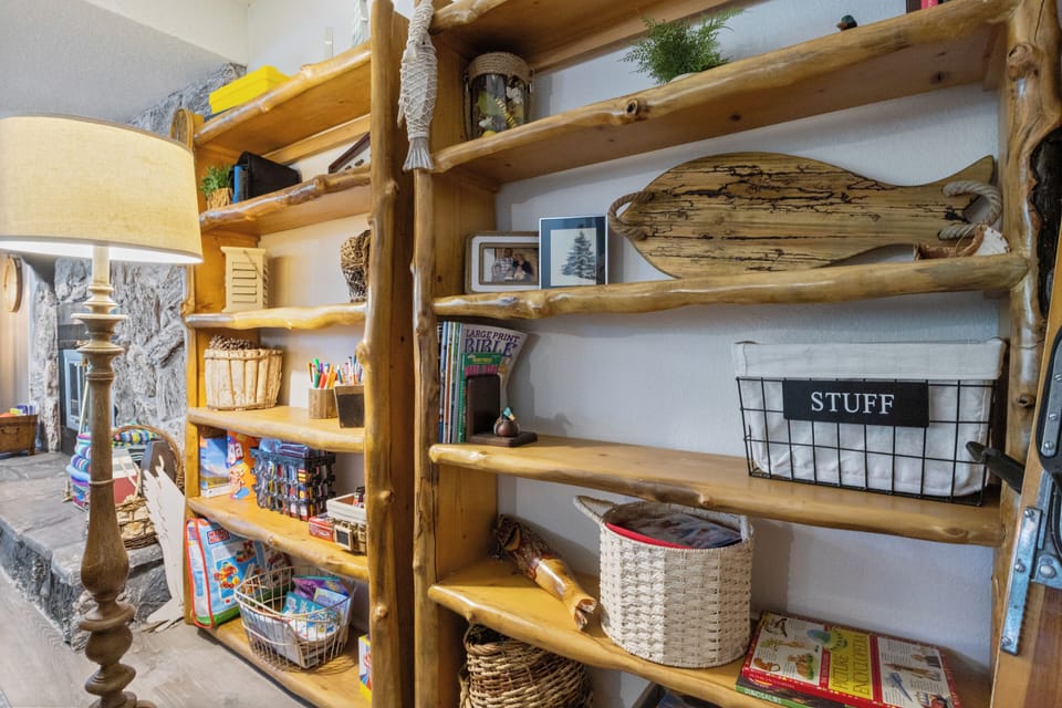 Organized bookshelf with rustic decor and family games