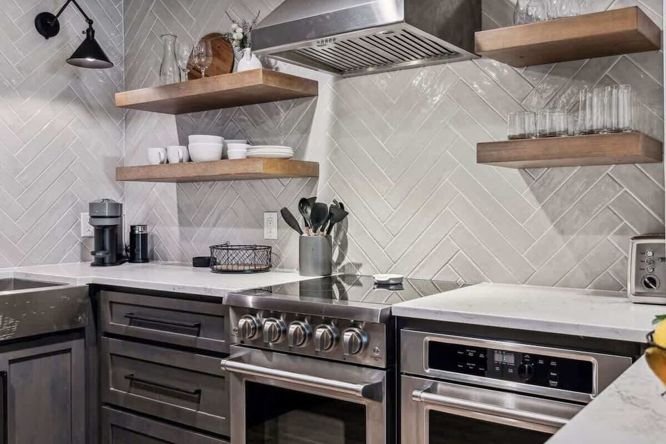 Fully equipped kitchen boasting stainless steel appliances and stocked with all culinary essentials.