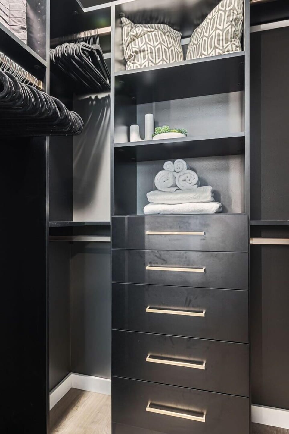 Primary Bedroom featuring a King Bed, Smart TV, a walk-in closet and getting-ready space.