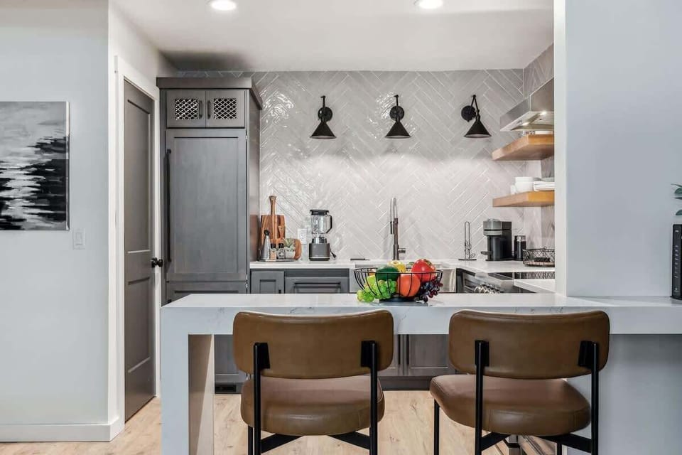 Fully equipped kitchen boasting stainless steel appliances and stocked with all culinary essentials.