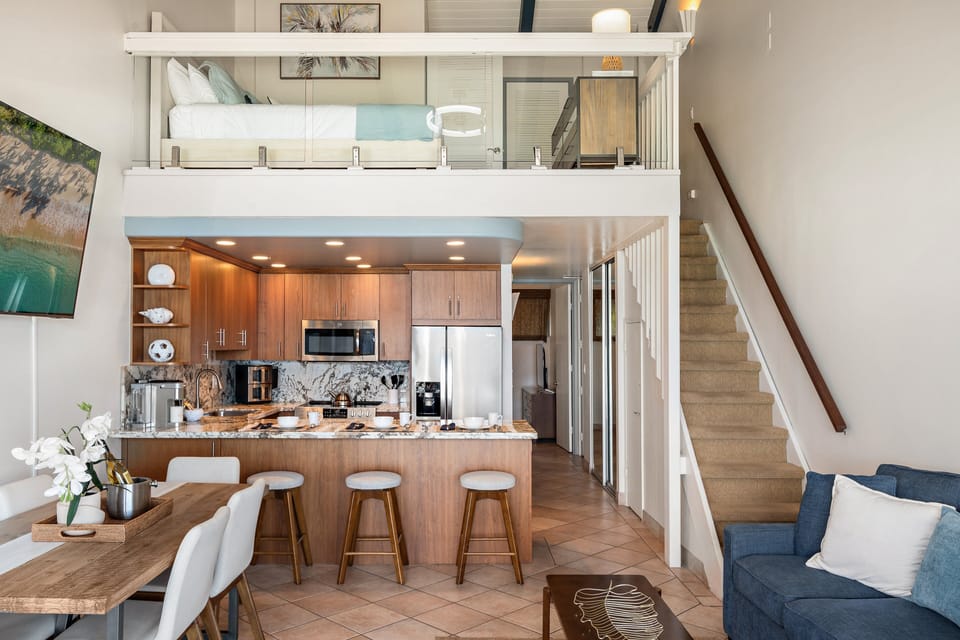 Prepare meals with ease in the spacious kitchen featuring stainless steel appliances and a convenient breakfast bar.