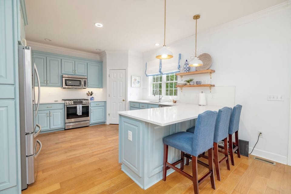 Kitchen ahead of you.  Granite, stainless, 3 barstools