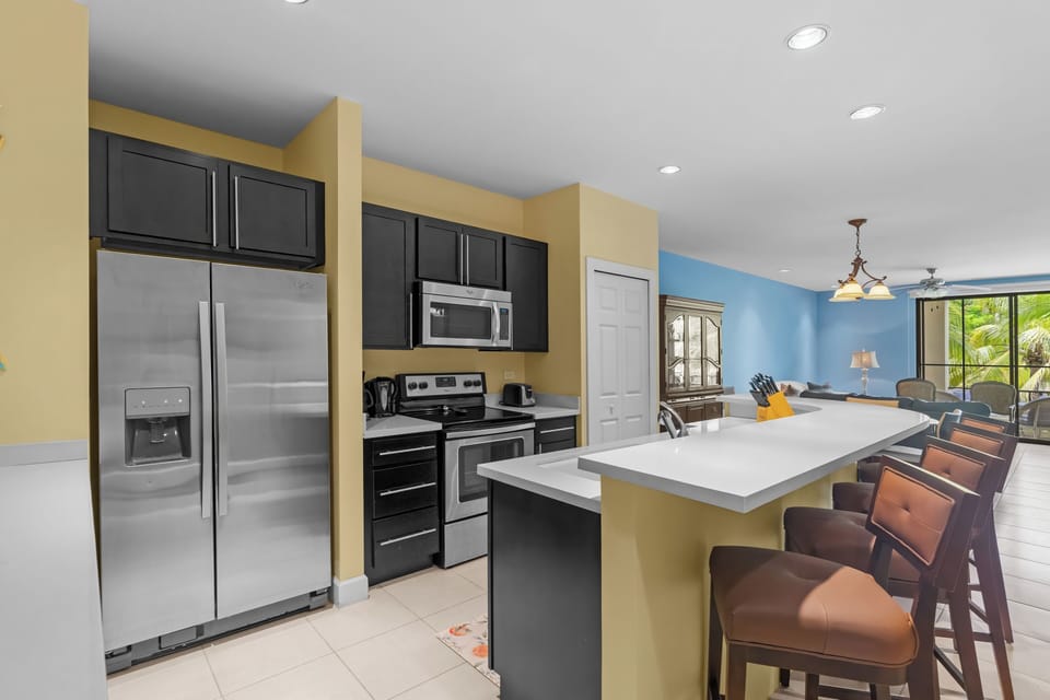The updated kitchen features Whirlpool appliances and a stacked washer/dryer.