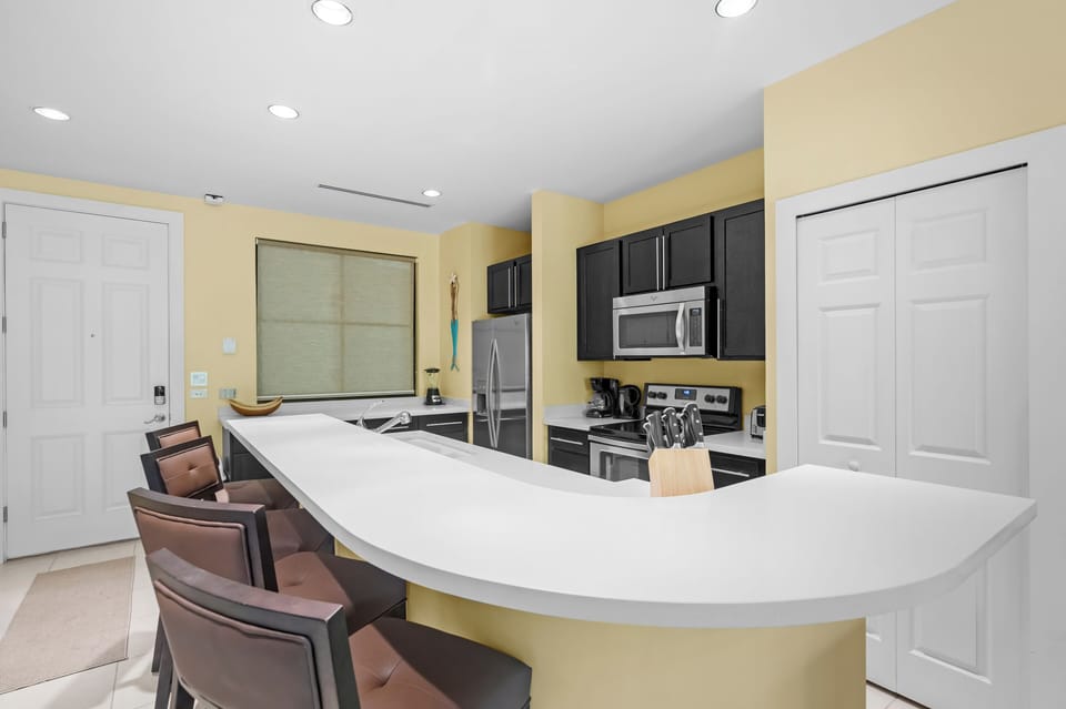 The updated kitchen features Whirlpool appliances and a stacked washer/dryer.