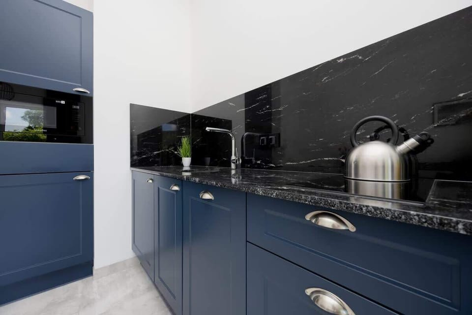 The sleek design of the kitchenette blending seamlessly with the living area.