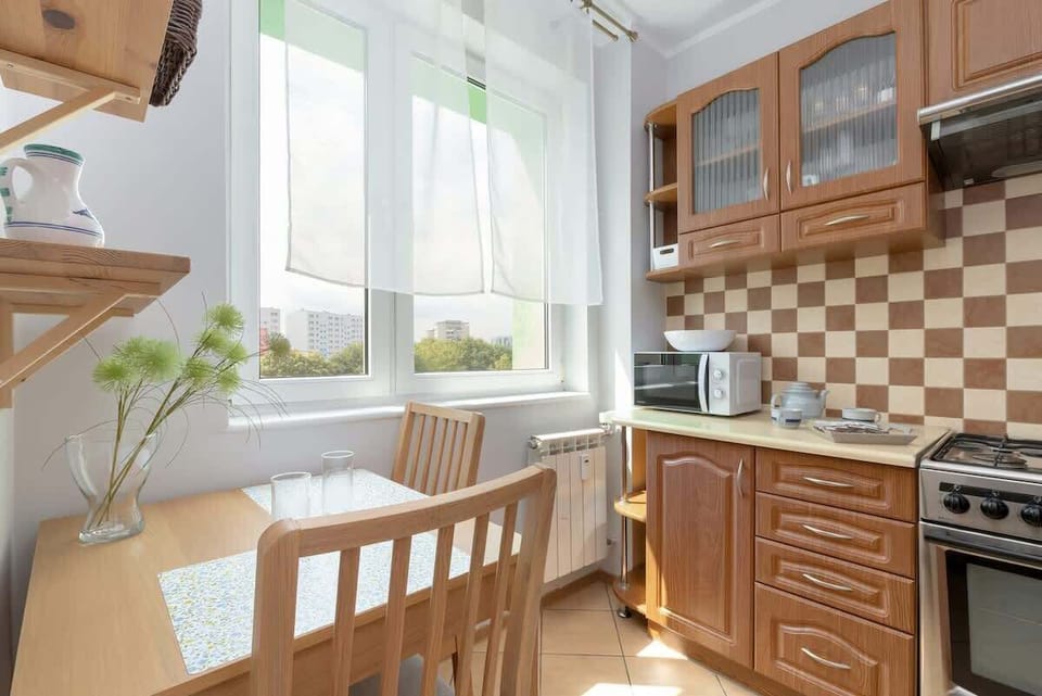 The kitchen's sleek design includes all necessary cookware and utensils. 