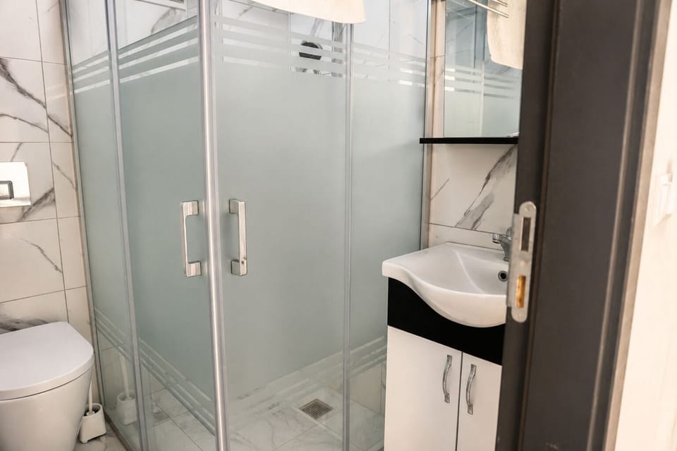 Shower, rainfall showerhead, hair dryer, towels