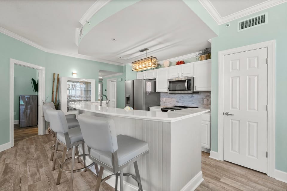 The updated kitchen features a large kitchen island, granite countertops, stainless-steel appliances, spacious pantry, and everything you need to prepare meals for family & friends.