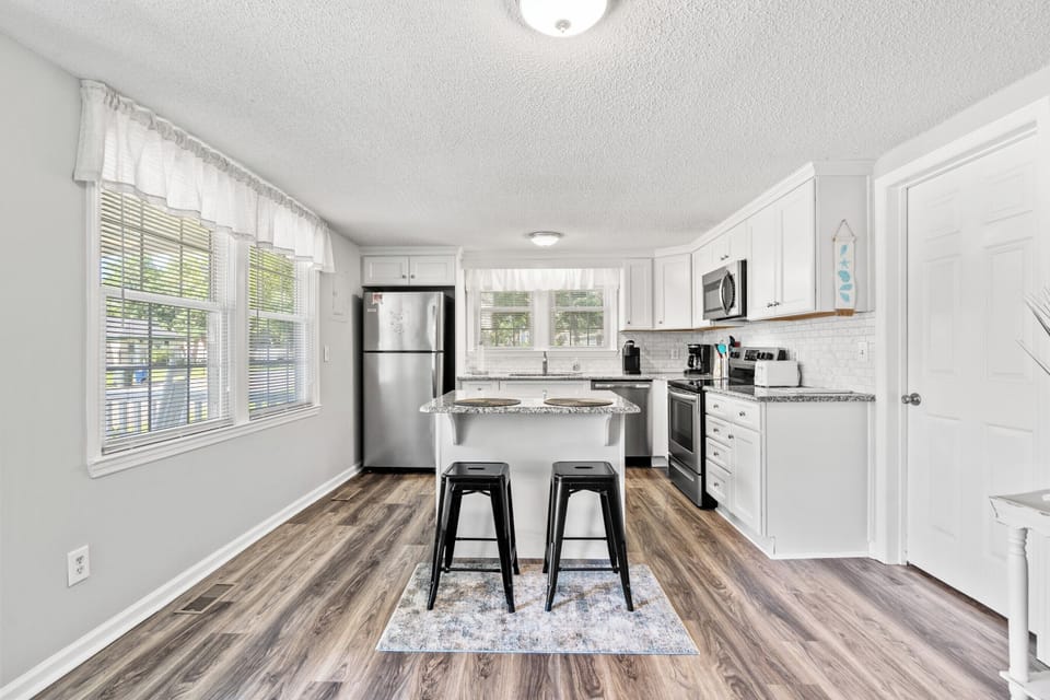 The kitchen island provides additional counter space for serving snacks or meals