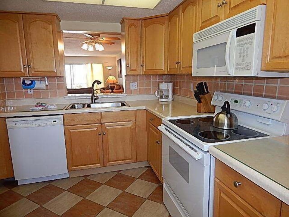 Kitchen Area - Fully equipped kitchen with pass-through to dining area.