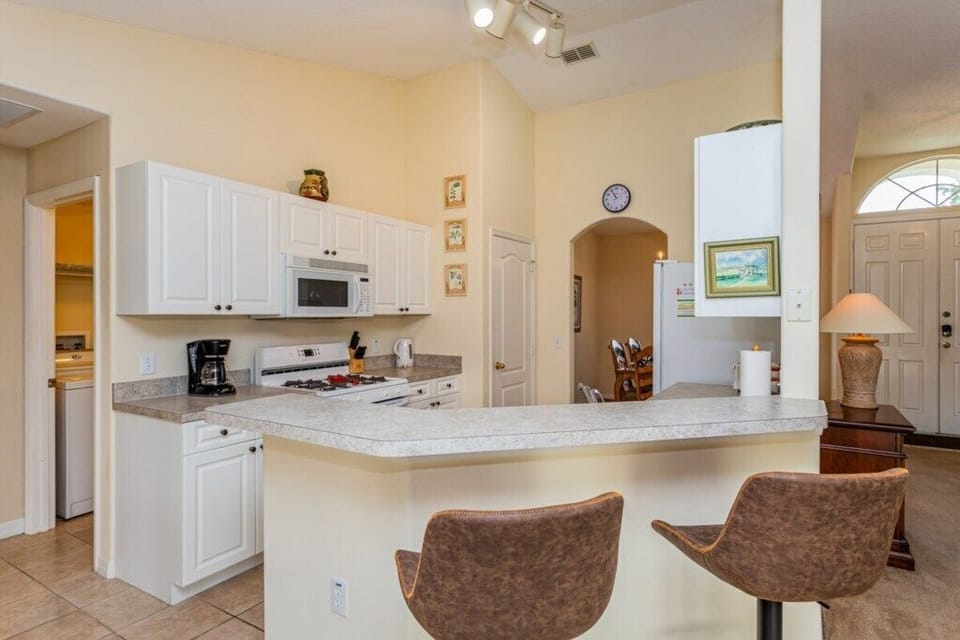 Fully equipped kitchen with breakfast bar seating for your convenience.