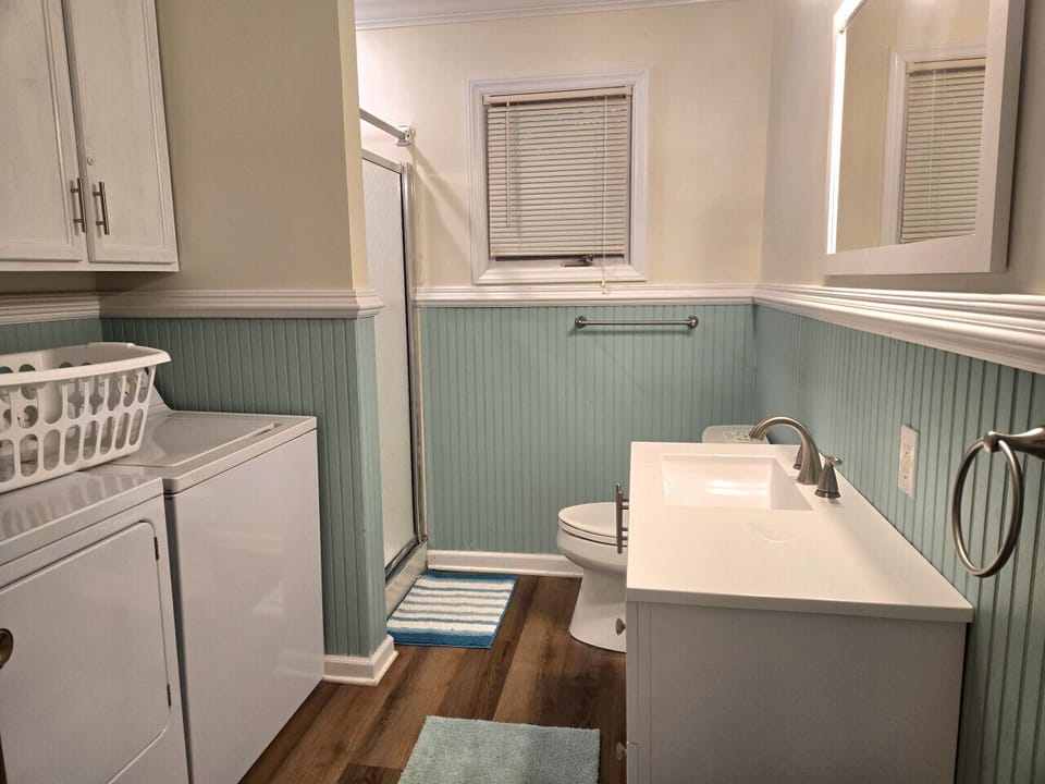 The bathroom includes a shower and washer and dryer.