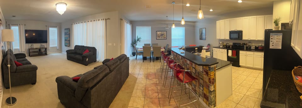 Kitchen with Breakfast bar overlooking the Dining area and open plan lounge 