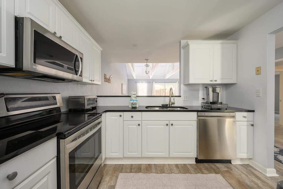 The open-concept design includes a breakfast bar/pass-through window.