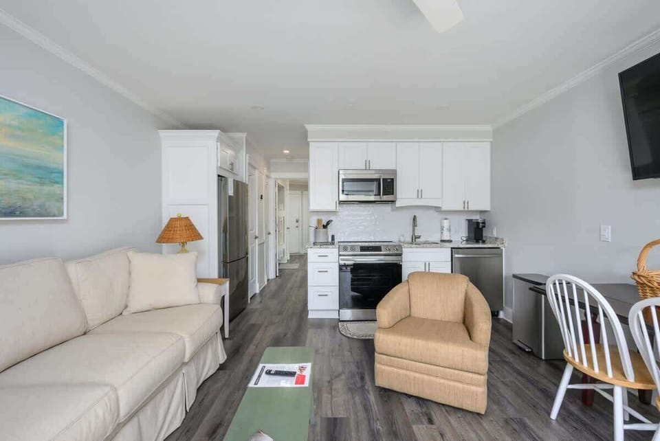 The living area is bathed in natural light thanks to large sliding glass doors.