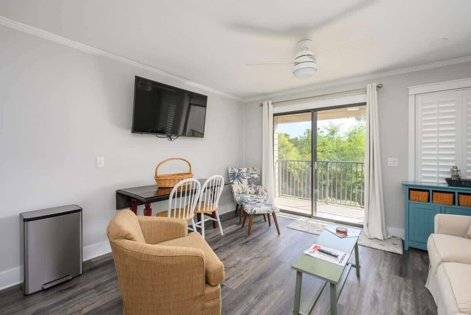 The living room is bathed in natural light from large sliding glass doors.