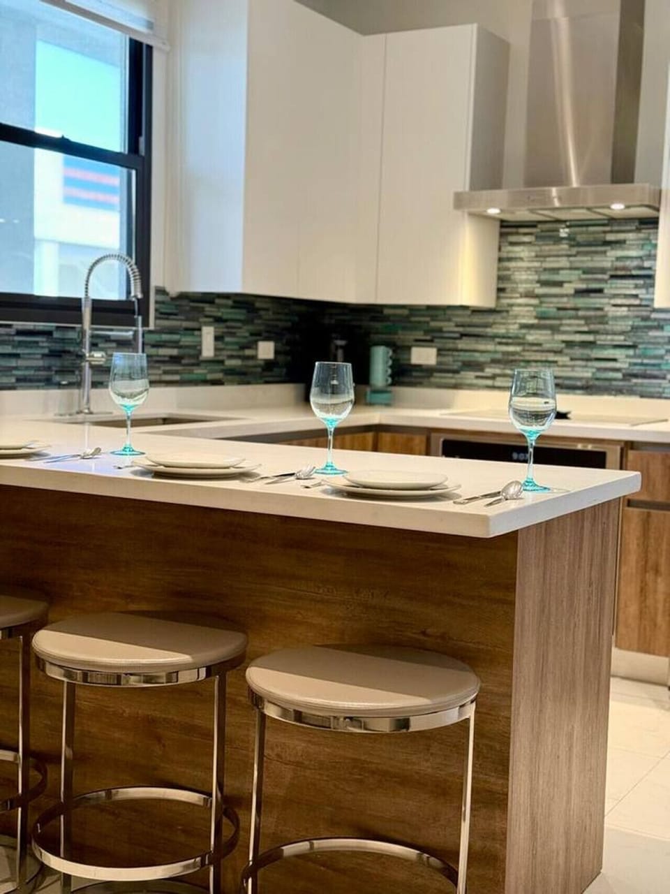 A sleek, fully equipped kitchen with a breakfast bar—perfect for slow mornings or a quick bite before heading out.