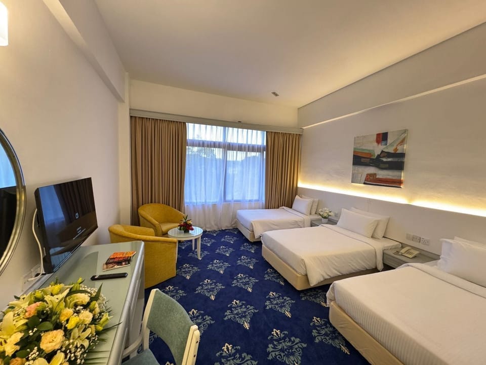 Deluxe Triple Room | Minibar, in-room safe, laptop workspace, iron/ironing board