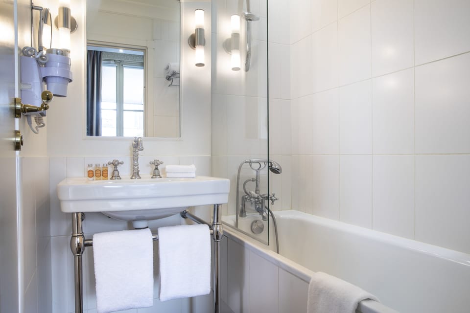 Bathtub, hair dryer, bathrobes, slippers