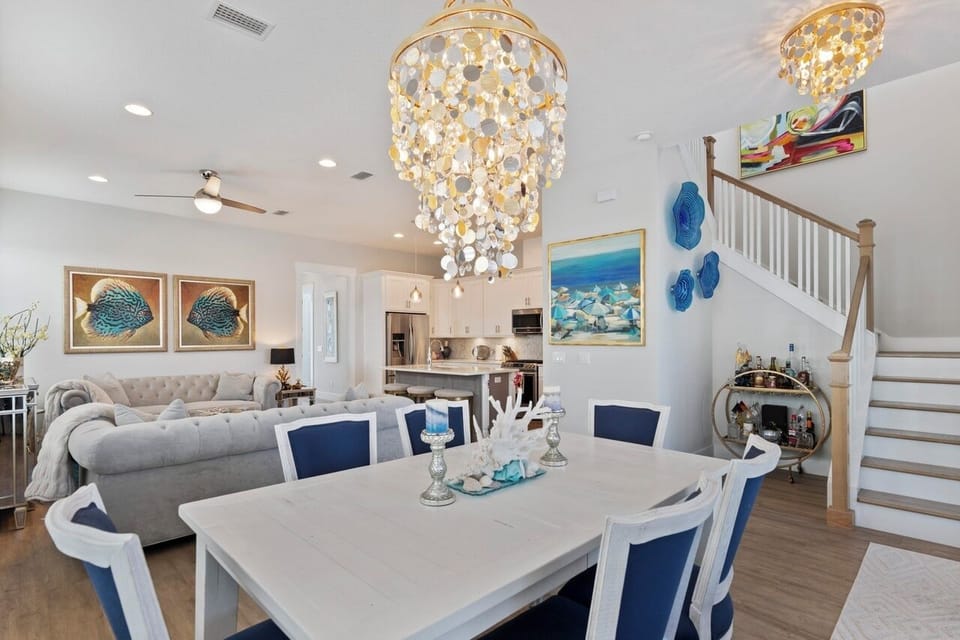Relax in your elegant dining room with stunning chandeliers, where you'll enjoy meals surrounded by beautiful coastal artwork and thoughtful décor.