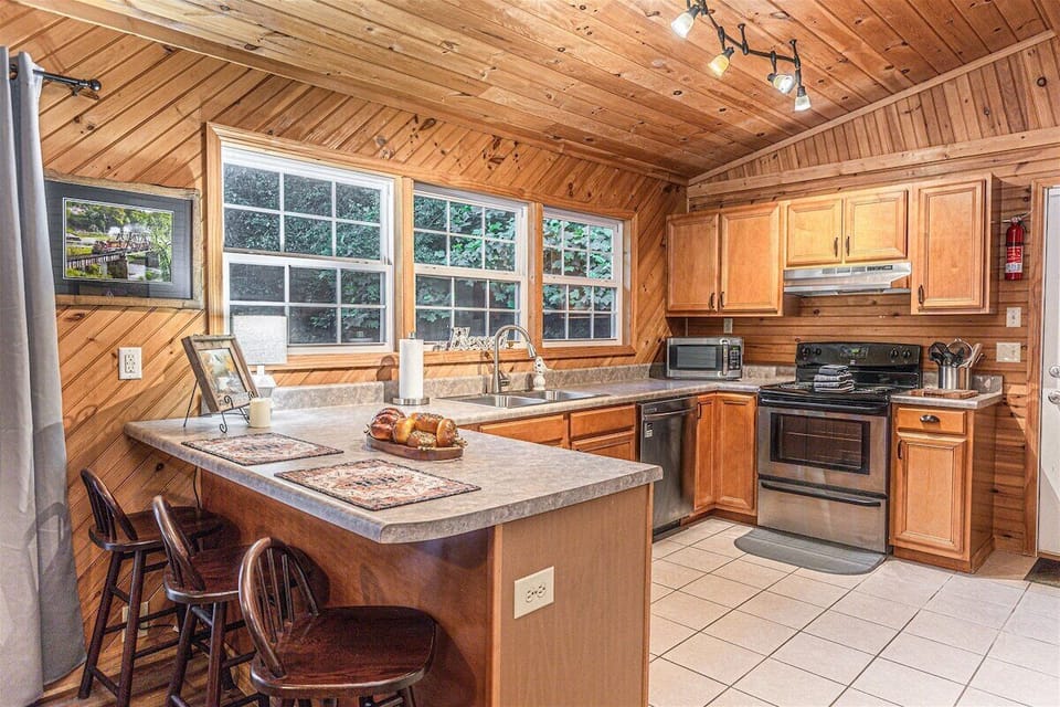 Fully equipped kitchen with ample counter space and window views.